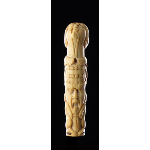 A Finely Carved Sword or Dagger Handle with a Female Head Two Grimacing Faces Flanked by Two Kneeling Naked Figures